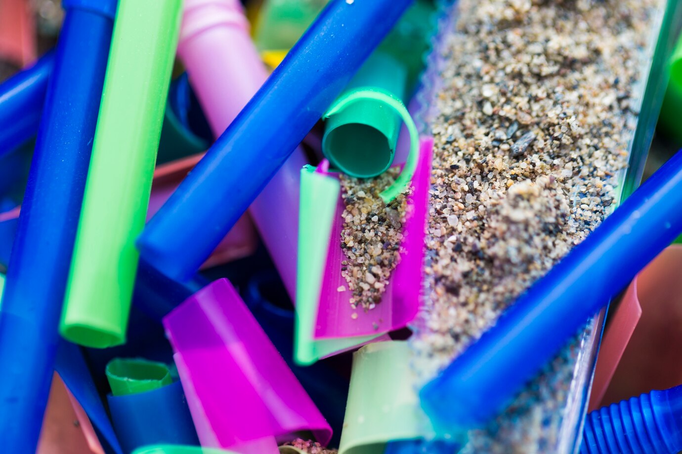 close-up-plastic-pieces-collected-from-sand_23-2148502832